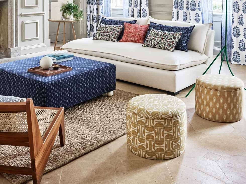 Living room featuring a white sofa, patterned curtains, colorful cushions, and showcasing a blend of comfort and style - Beautiful Homes
