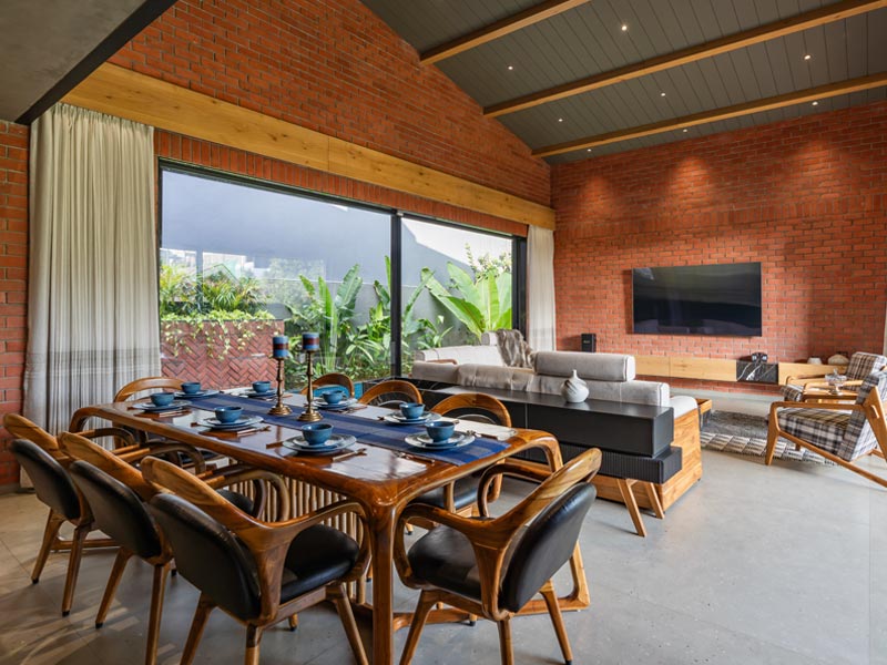 Spacious double-height living and dining area with striking sloping roof design – Beautiful Homes