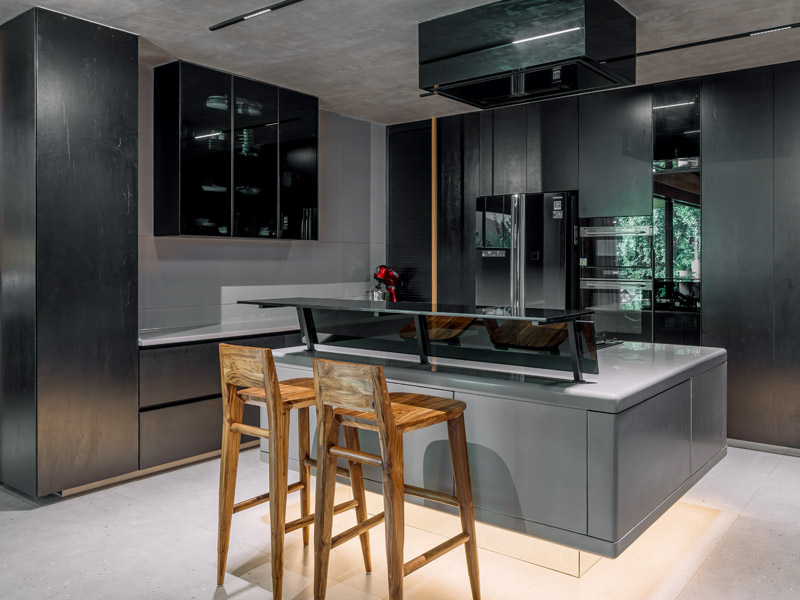 Sleek kitchen with grey and black interiors contrasting the warm brick tones – Beautiful Homes