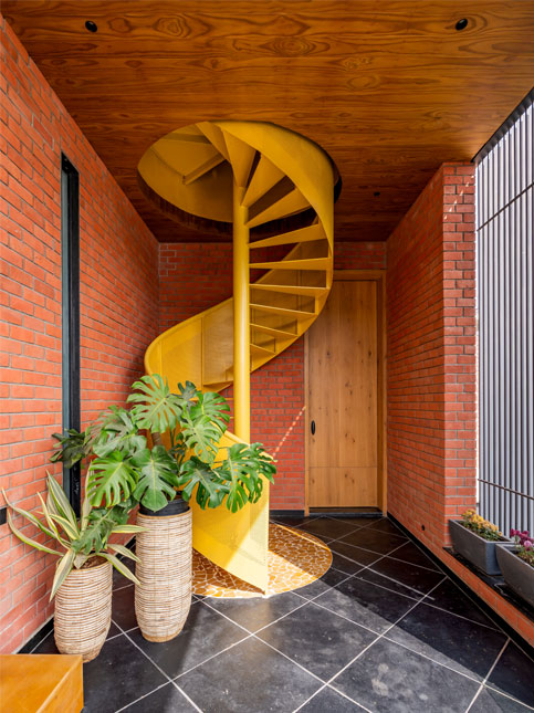 Bold yellow spiral staircase adding a playful design element to the interiors – Beautiful Homes