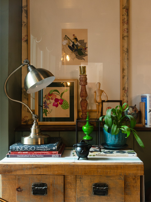 Chest with Devi artwork, vintage candlestand, and green artefact – Beautiful Homes