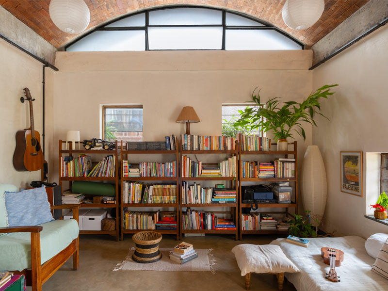 The living area skips a conventional sofa set and TV arrangement, with low seating and open floors instead – a layout that makes space for music, reading and their son to play freely – Beautiful Homes