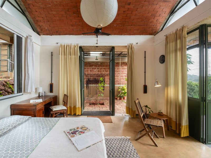 The guest suite is a self-contained unit with its own entrance, access to the kitchen, and a quiet terrace just outside. Vaulted ceilings, lime-plastered walls and minimal, movable furniture give the space a relaxed, open feel – Beautiful Homes