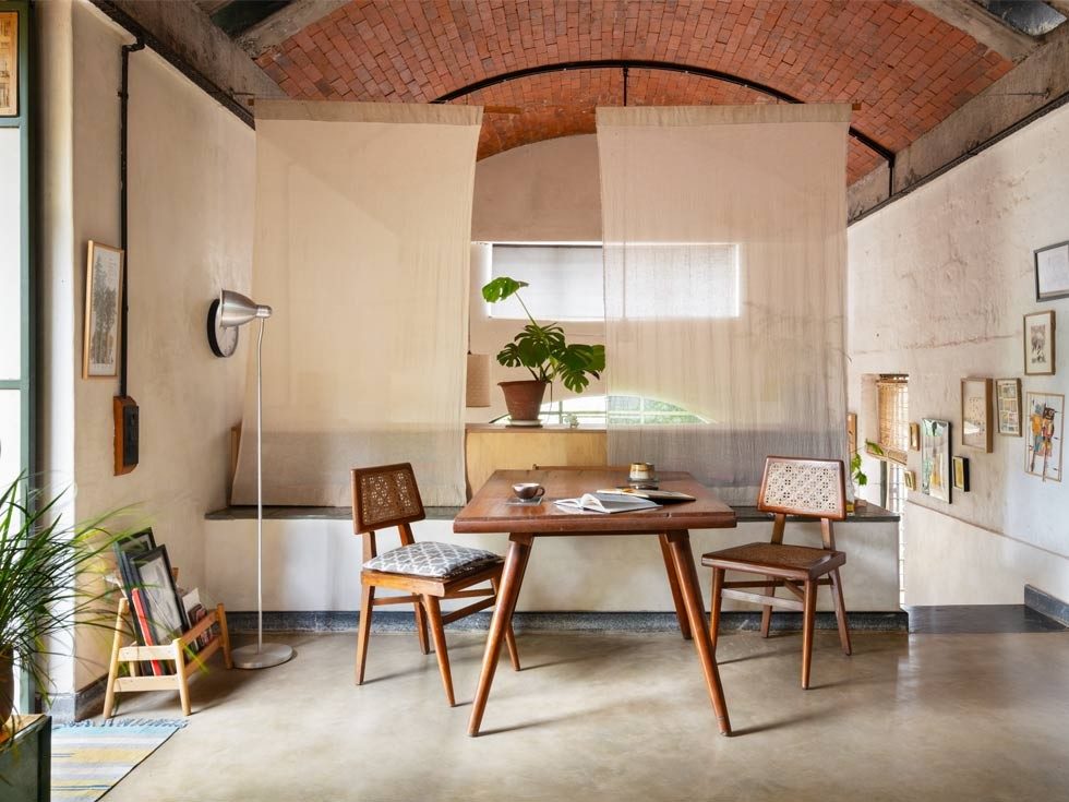 The living area sits directly above the couple’s bedroom and is intentionally sparse, with movable furniture and cloth screens that offer flexibility and privacy without interrupting the open plan – Beautiful Homes
