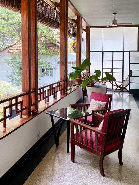 Serene verandah at Malabar House with tropical greenery – Beautiful Homes