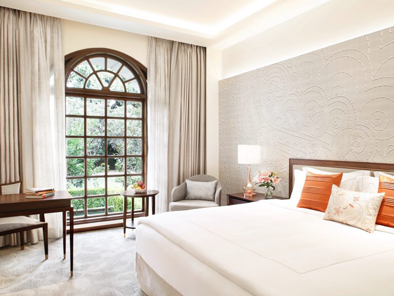 Elegant Taj Lucknow bedroom with arched window and textured wall – Beautiful Homes