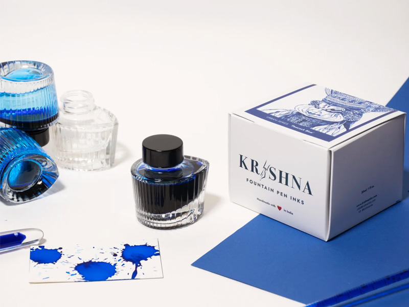Krishna Fountain Pen Inks with bottles, ink splatters, and the product box– Beautiful Homes