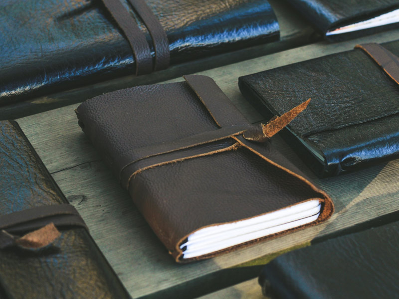 Multiple small leather-bound notebooks with leather straps – Beautiful Homes
