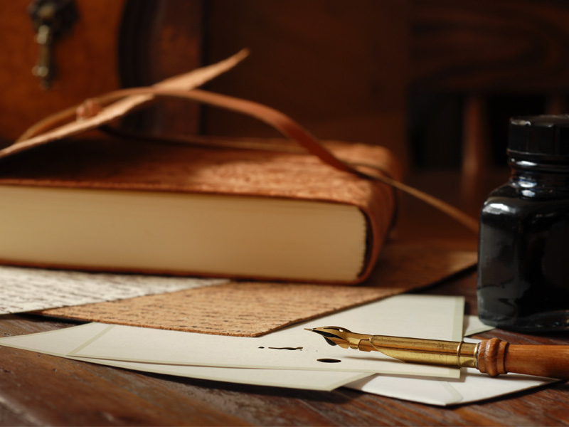 An old-style wooden dip pen, an ink bottle, and a leather-bound journal – Beautiful Homes