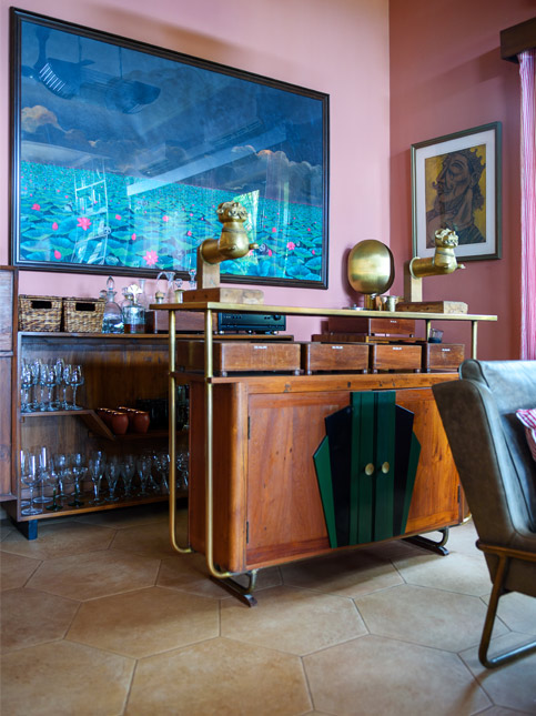 Art Deco-style bar cabinet with brass accents and framed wall art – Beautiful Homes