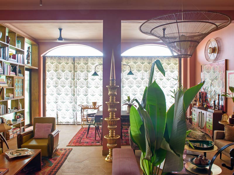 Eclectic living room with Indian decor, patterned curtains, and warm earthy tones – Beautiful Homes
