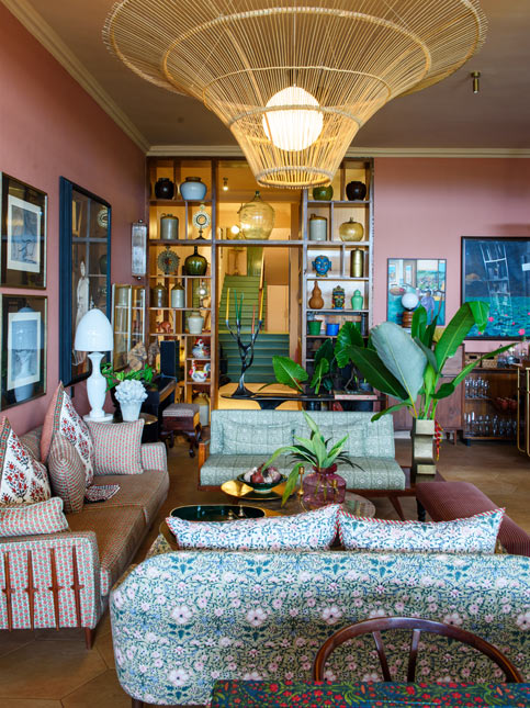 Eclectic living room with patterned sofas, vibrant art, and statement lighting – Beautiful Homes