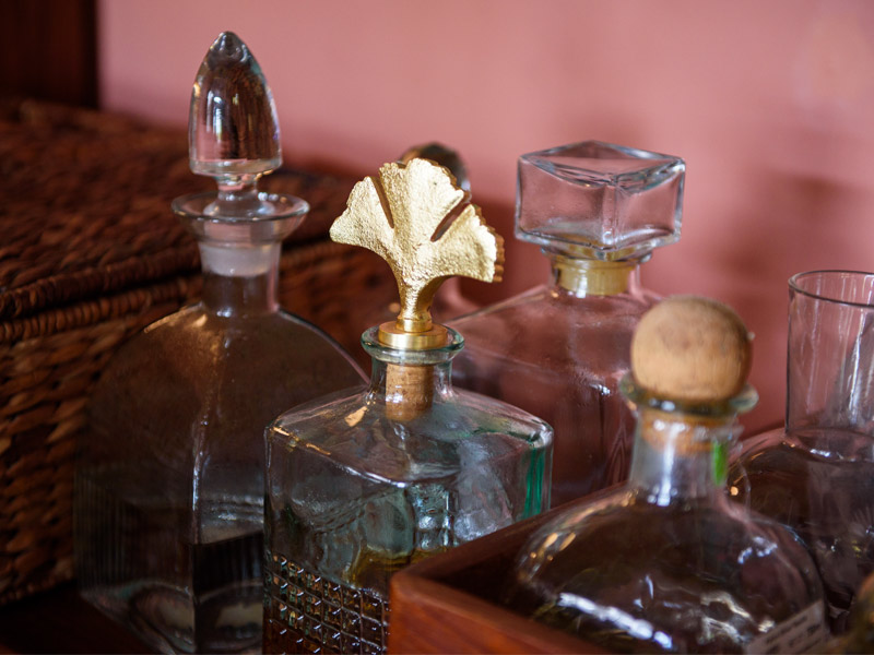 Vintage glass decanters with intricate stoppers and golden leaf detail – Beautiful Homes