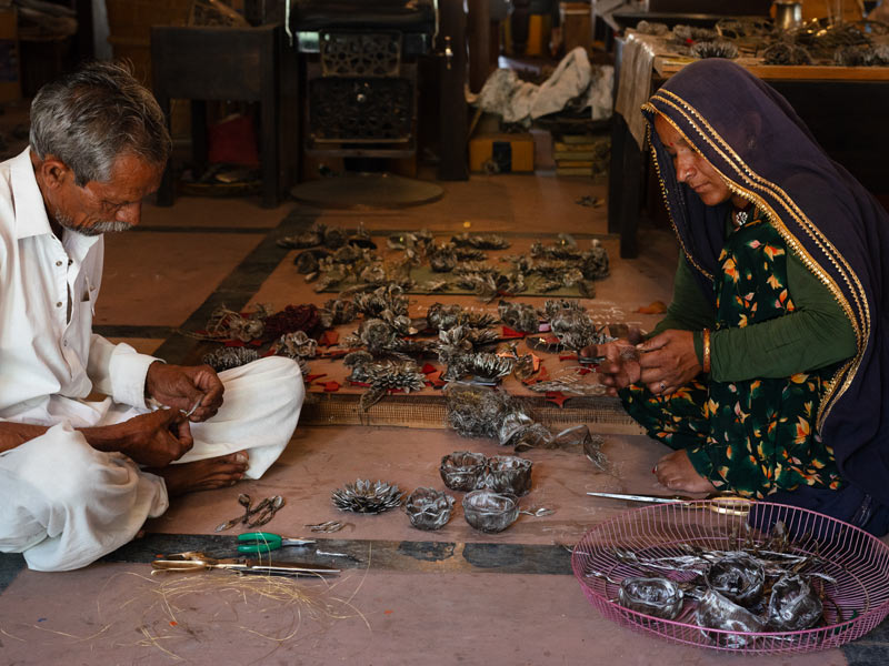 Artisans Baba and Rekha working on floral artworks - Beautiful Homes
