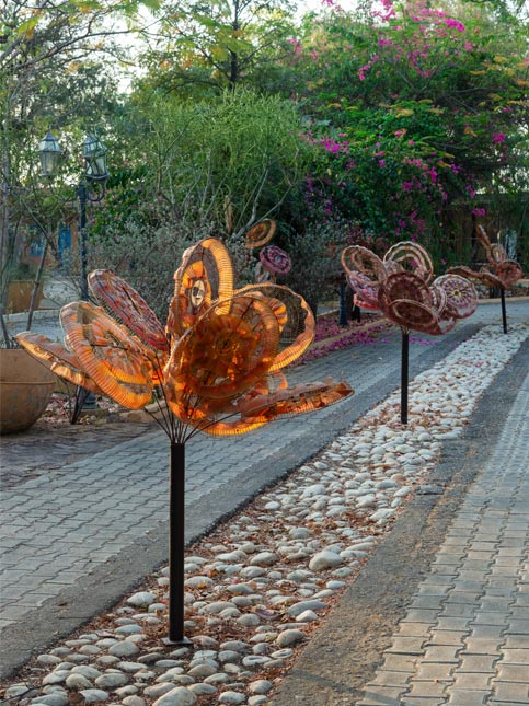 Metal flower installations along the studio walkway - Beautiful Homes