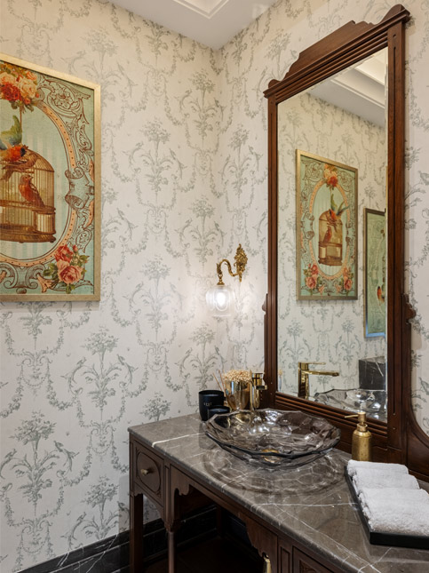 A powder bathroom features locally sourced wallpaper and custom cabinetry - Beautiful Homes