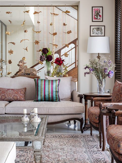 The custom designed installation in the living room adds as a staircase divider - Beautiful Homes