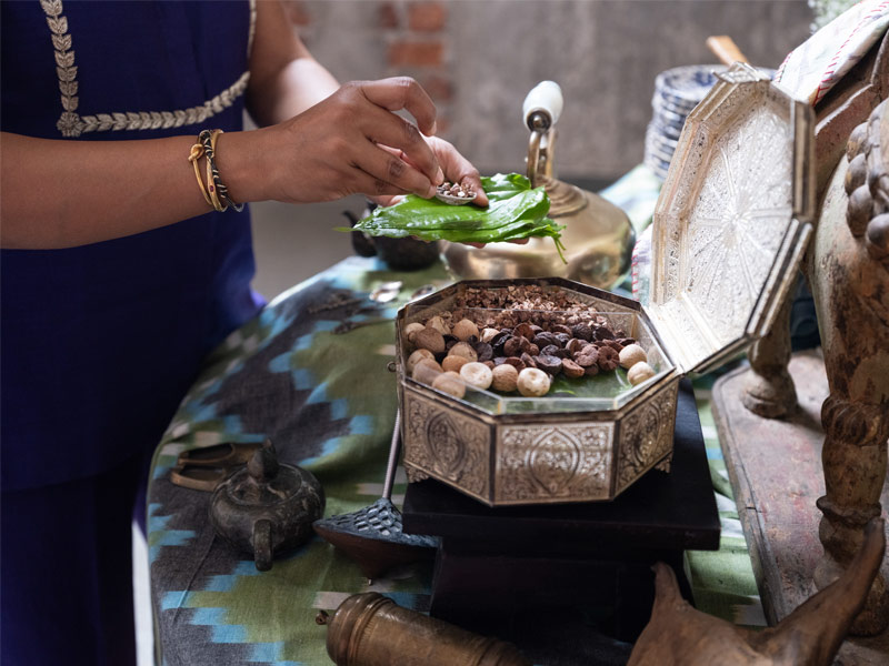 A filigree paandan anchors the side table, bringing a touch of ritual and local craft to the setting – Beautiful Homes