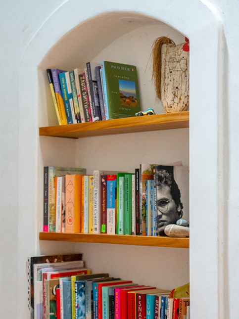Arched wall bookshelf filled with colourful books – Beautiful Homes