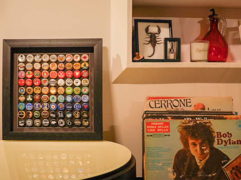 A framed collection of bottle caps saved by Karina - Beautiful Homes