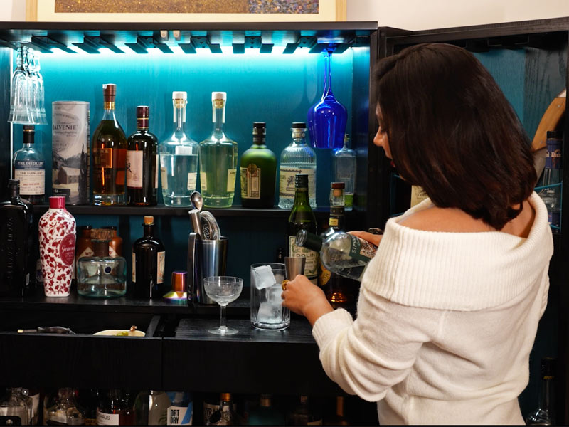 Woman mixing drink at home – Beautiful Homes