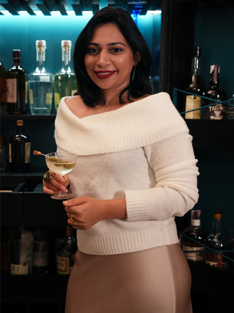 Woman holding a martini at home bar – Beautiful Homes