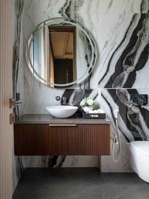 Powder room with veined stone mirror – Beautiful Homes