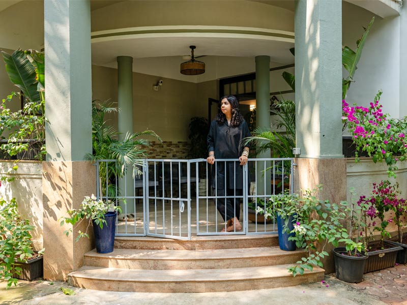 Lakshmi on veranda of Maudestan – Beautiful Homes