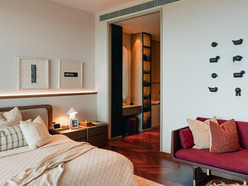 Bedroom with burgundy sofa and art – Beautiful Homes