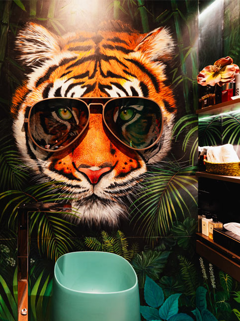 Powder room with hand-painted tiger mural – Beautiful Homes