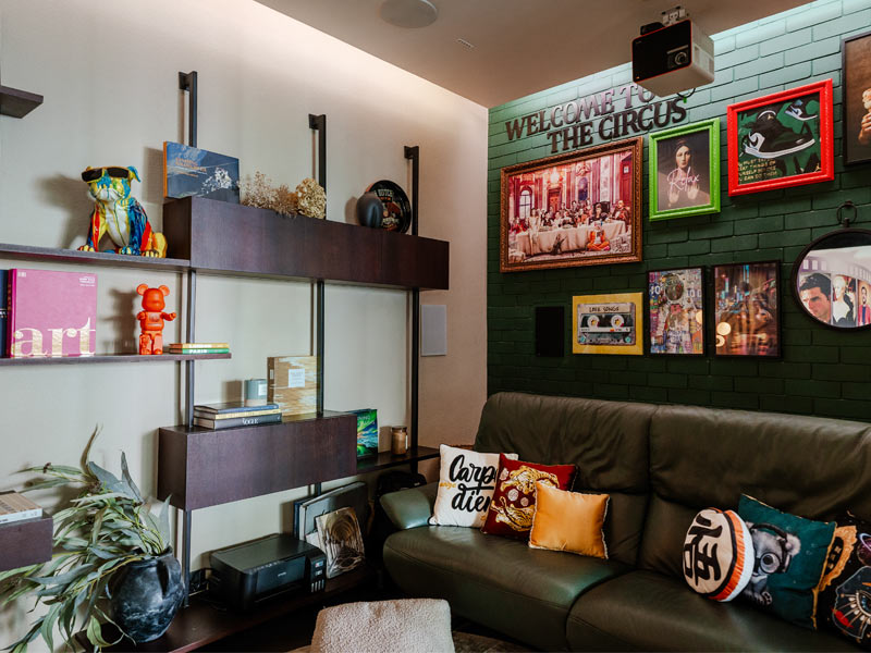 Den with green wall and collectibles – Beautiful Homes