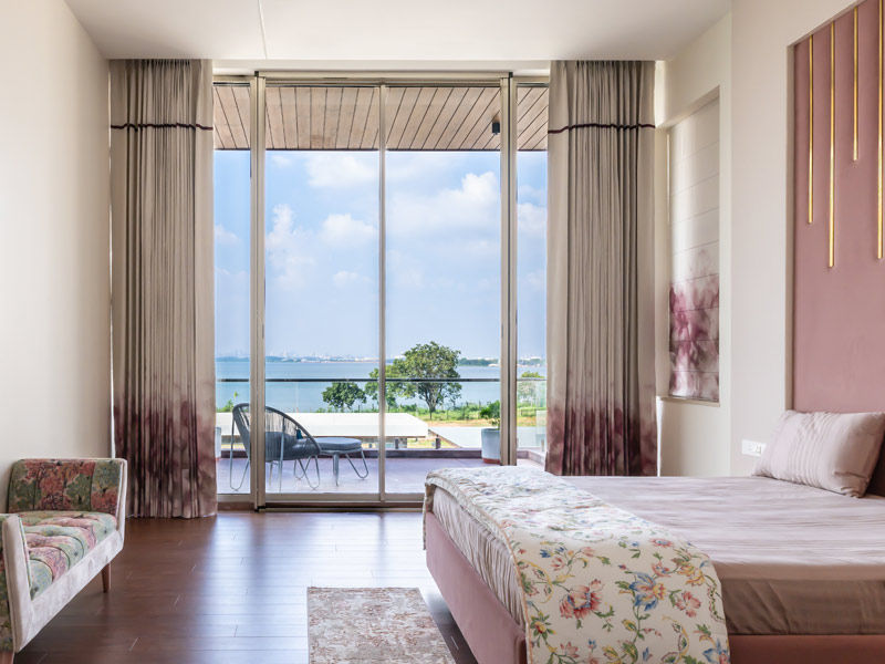 Bedroom with wooden flooring and lake views – Beautiful Homes