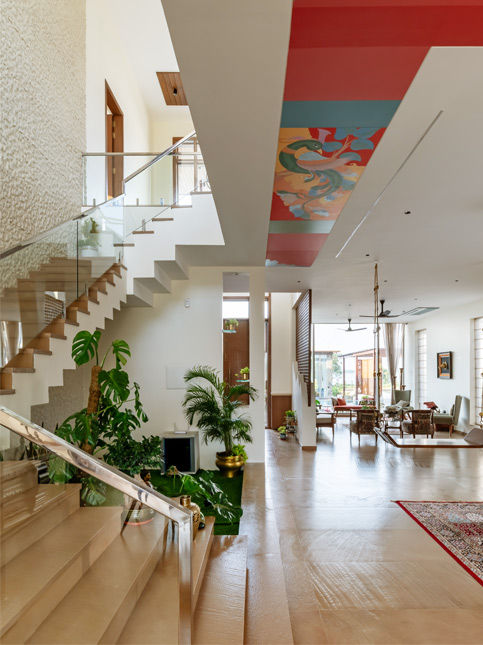 Timber staircase with glass balustrade and greenery – Beautiful Homes