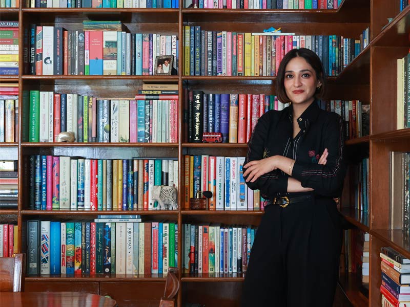 Aanchal beside L-shaped bookshelf – Beautiful Homes