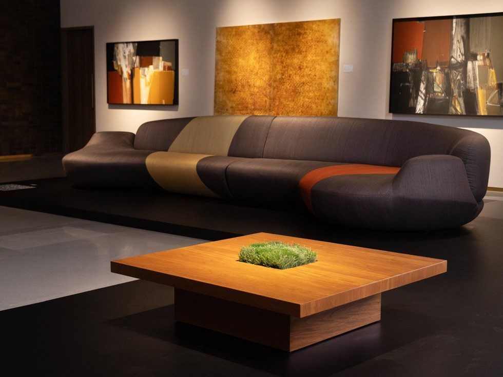 Modern sectional sofa with coffee table in gallery setting - Beautiful Homes