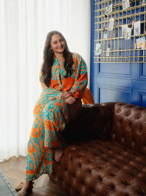 Sonakshi relaxing by blue travel wall – Beautiful Homes