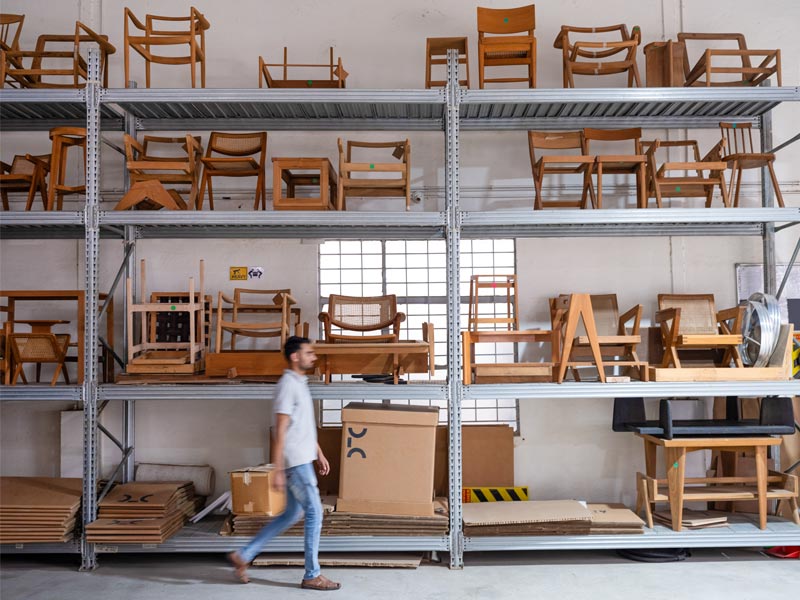 A wall of prototypes and samples documents years of experimentation: joints, finishes, curves, failures, breakthroughs – Beautiful Homes