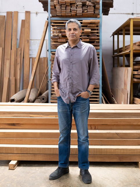 Co-founder Deepak Srinath stands in Phantom Hands’ wood-storage unit – Beautiful Homes