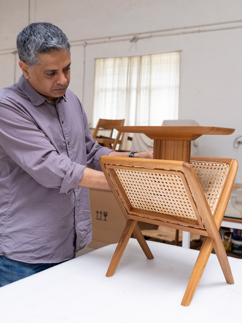 Deepak Srinath inspects the Muṅgāru Side Table at the in-house quality checking unit – Beautiful Homes