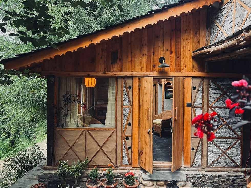 Another view of The Wild Apricot highlights its ease with terrain—stone plinths meeting slopes, timber frames opening to forest, and proportions that follow regional rhythms – Beautiful Homes
