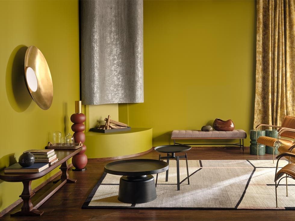 Living room with Moonlit Silk green walls, modern furniture and brass accents – Beautiful Homes