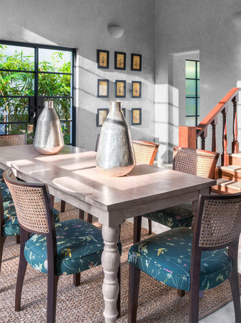The dining chairs sourced from Gulmohar Lane while the botanical photo frames are from The Flame Store, Goa – Beautiful Homes