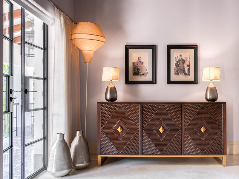 The Japanese postcard artwork on the wall along with the bespoke floor lamp are sourced from The Flame Store, Goa – Beautiful Homes