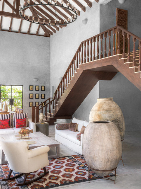 The red mashru cushions and the vintage rug is from designer, stylist and collector Ranji Kelekar’s Goa studio – Beautiful Homes