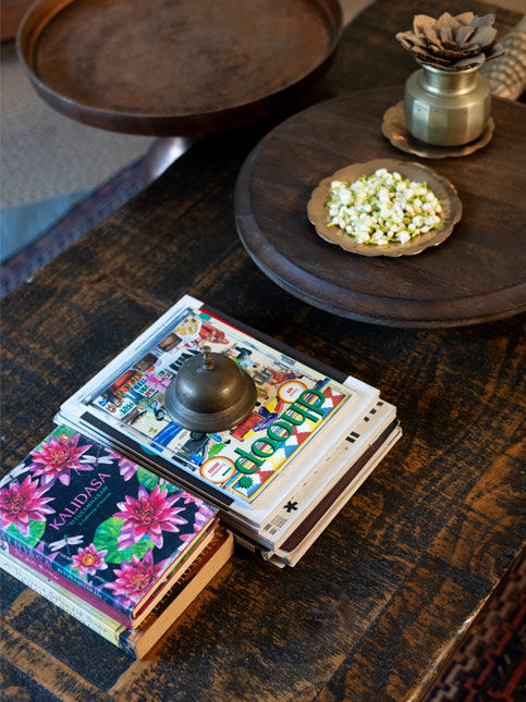 Books, brass decor and flowers arranged on wooden table – Beautiful Homes