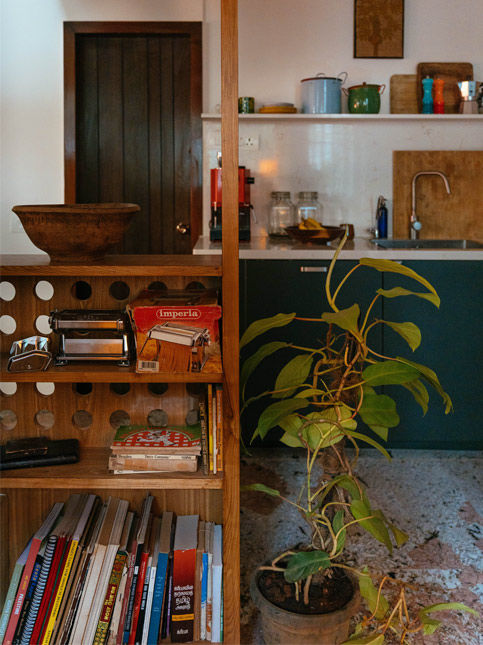 The pod, a semi enclosed space in the kitchen, is lined with books, including Nia’s extensive cookbook collection – Beautiful Homes