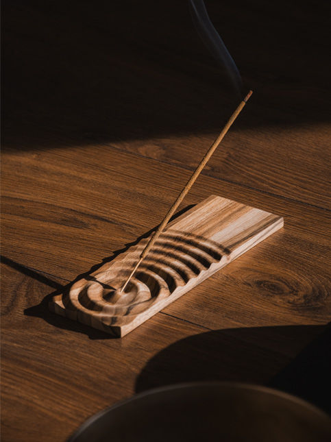 Burning incense stick on a wooden incense holder – Beautiful Homes
