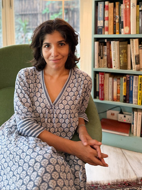 Chiki Sarkar seated in a cozy reading corner with a bookshelf – Beautiful Homes