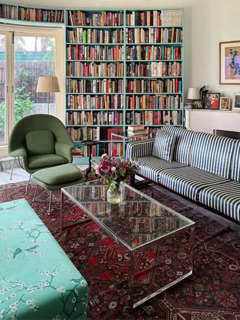 Colourful home library with bookshelf, striped sofa and glass coffee table – Beautiful Homes