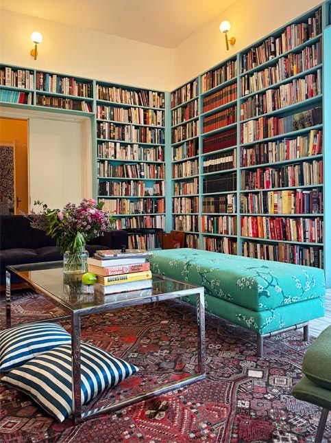 Cozy library living room with bookshelves and ottoman – Beautiful Homes